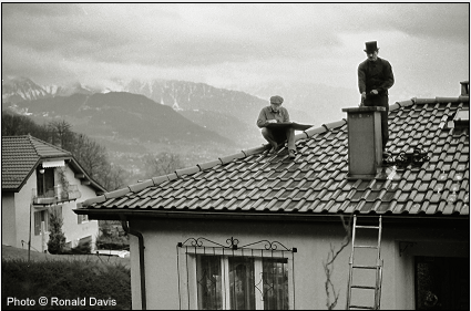 Stanley Roseman drawing the chimney sweep Marc-Andr on a rooftop in the Lavaux region of Switzerland, 1993.  Photo by Ronald Davis